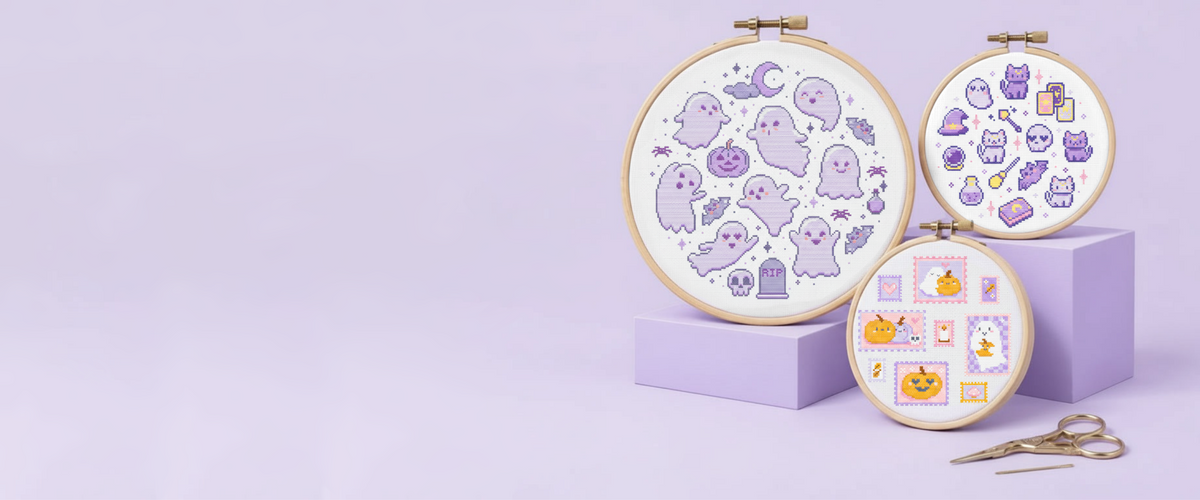 Kawaii Halloween cross stitch patterns displayed in embroidery hoops